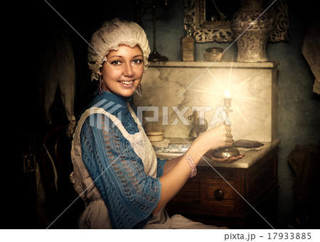 woman in old cap with candlestick 17933885