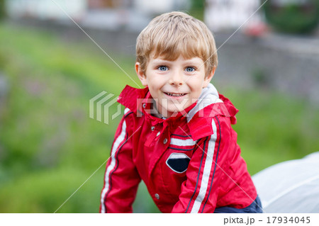 Portrait of little schoolboy outdoors on rainy day 17934045