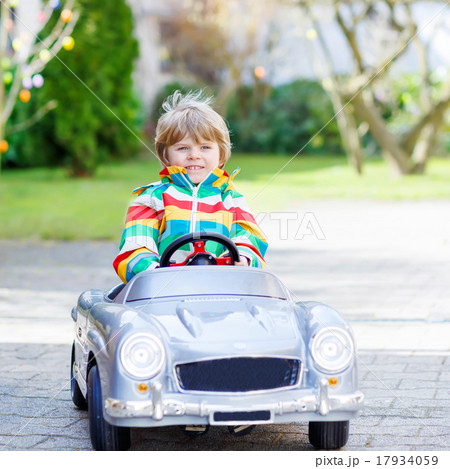 Little preschool boy driving big toy old car Little preschool boy driving big toy old car 17934059