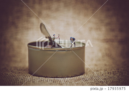 Miniature workers opening a can 17935975