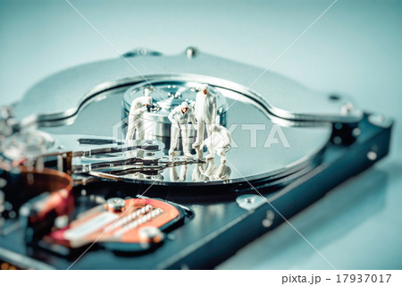 Group of criminalists inspecting hard drive Group of criminalists inspecting hard drive 17937017