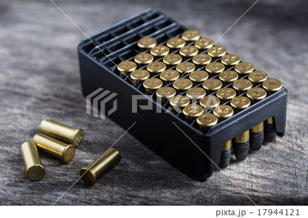 Scattering of small caliber cartridges on a wooden 17944121