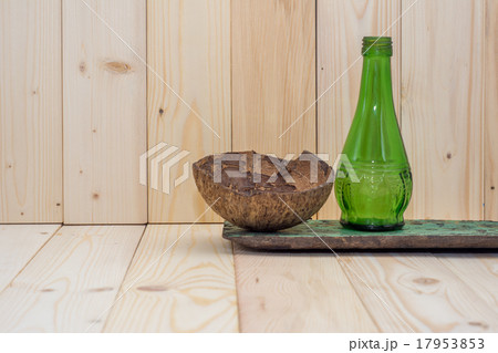 Coconut shell with green glass bottles Coconut shell with green glass bottles 17953853