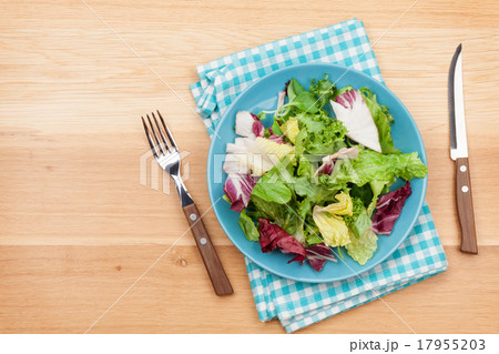 Plate with fresh salad, knife and fork. Diet food Plate with fresh salad, knife and fork. Diet food 17955203