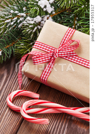 Christmas gift box, candy cane and tree branch Christmas gift box, candy cane and tree branch 17955317