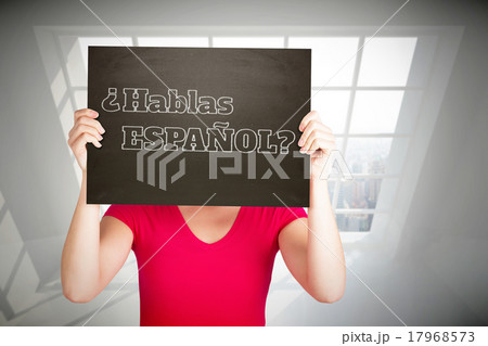 Composite image of casual woman showing board 17968573