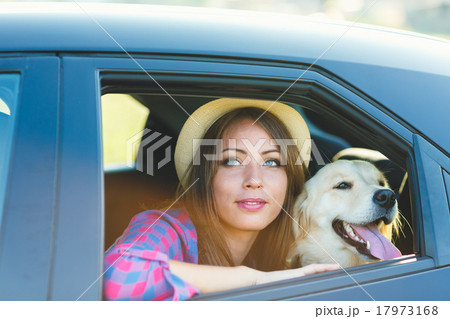 Woman and dog in car on summer travel Woman and dog in car on summer travel 17973168