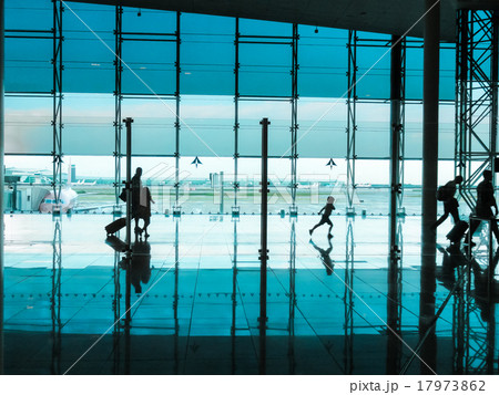 People with luggage walking at airport People with luggage walking at airport 17973862