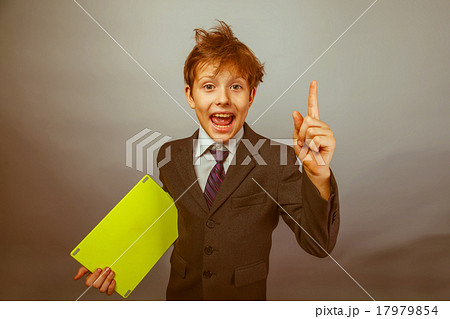 Teen boy businessman in a suit raised his finger 17979854
