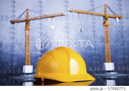 Construction plan with a crane and yellow helmet Construction plan with a crane and yellow helmet 17980771