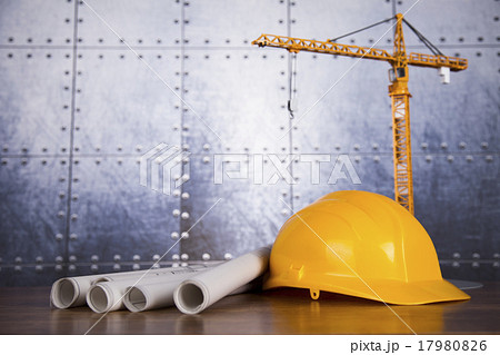 Construction plan with a crane and yellow helmet Construction plan with a crane and yellow helmet 17980826