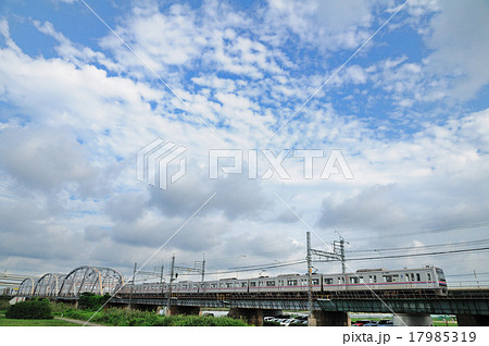 秋空の下荒川放水路にかかる堀切橋を渡って来る京成電車 17985319