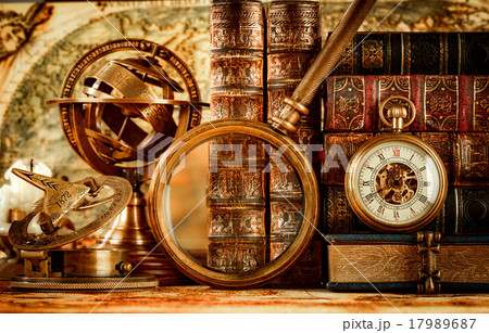 Vintage magnifying glass lies on an ancient world map 17989687