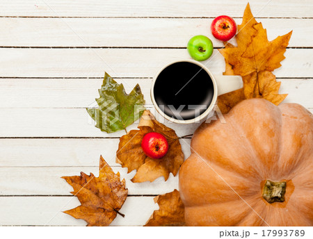 Cup of coffee and pumpkin with leafs 17993789
