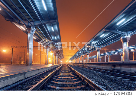 Railway station at night. Train platform in fog Railway station at night. Train platform in fog 17994802