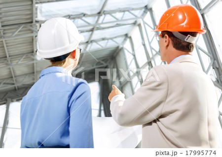 Professional architects discussing project Professional architects discussing project 17995774