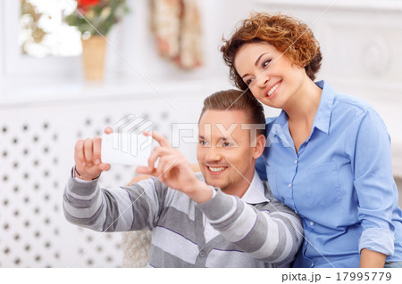 Pleasant couple sitting in the armchair  17995779