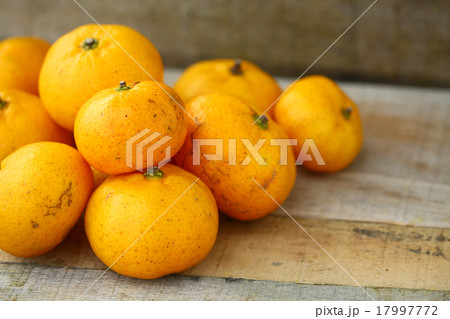 Fresh orange on wooden table in dining room.  17997772