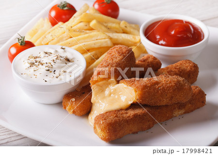 fried cheese and fries with sauce close-up 17998421