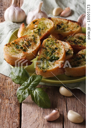 Bread with basil and garlic closeup on plate 18005173