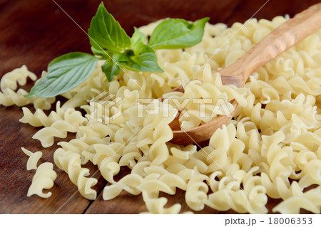Raw fusilli pasta background Raw fusilli pasta background 18006353