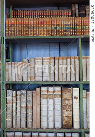 historic old books in library, wooden bookshelf 18006620
