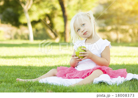 Little Girl In Grass Eating Healthy Apple Little Girl In Grass Eating Healthy Apple 18008373