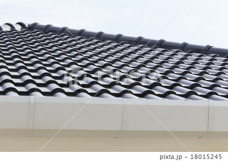 white gutter on the roof top of house 18015245