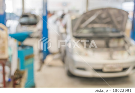 blur image of worker fixing car in ther garage. blur image of worker fixing car in ther garage. 18022991