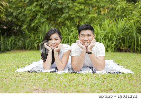 A young Asian couple enjoying a day in a park. 18031223