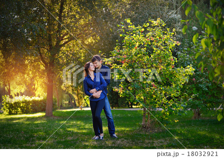 romantic teenage couple embracing outdoors 18032921