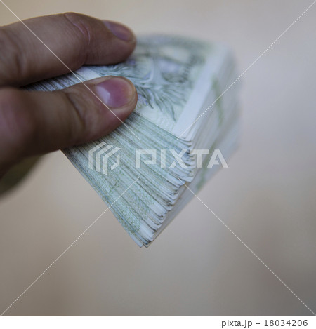 pack of money - big pile of banknotes in hand 18034206