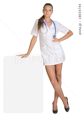Young woman doctor standing leaning hand on an 18034744