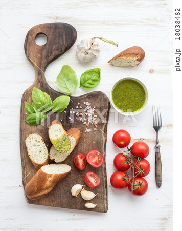 Pesto sauce, bread, cherry-tomatoes, fresh basil Pesto sauce, bread, cherry-tomatoes, fresh basil 18038482