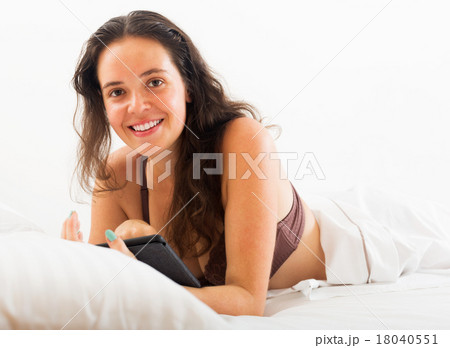 Woman with tablet in bed Woman with tablet in bed 18040551