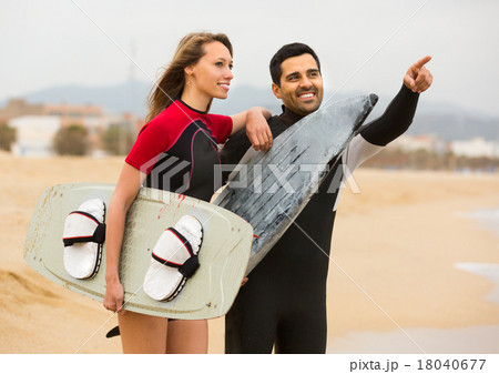 Couple with surf boards on the beach . 18040677