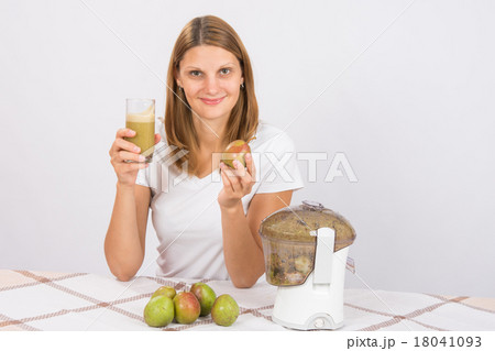 Girl with a pear and a glass of fresh juice in hand 18041093
