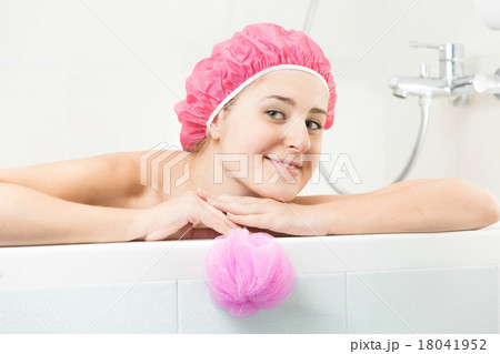 young woman in shower cap posing in bath 18041952