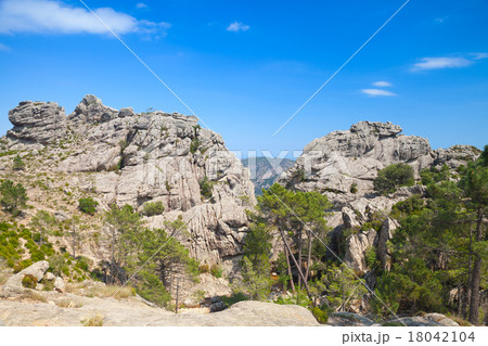 Wild mountain landscape, rocks under blue sky 18042104