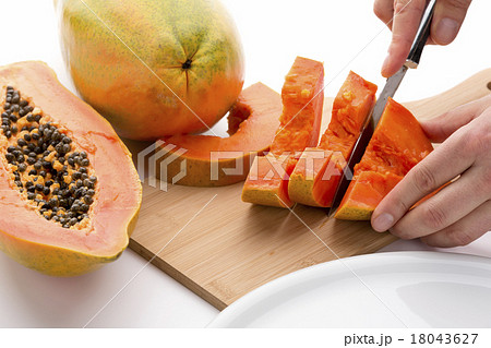 Half A Papaya Fruit Being Cut Into Slices Half A Papaya Fruit Being Cut Into Slices 18043627