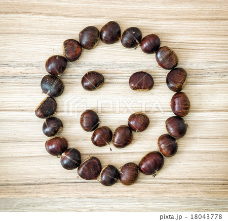 Chestnut smiley on the wooden plate 18043778