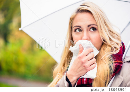 Woman having cold or flu due to bad autumn weather 18048994