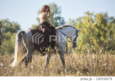 Beautiful girl riding a white horse Beautiful girl riding a white horse 18056879