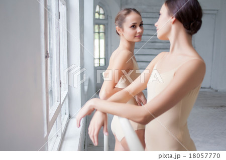 The two classic ballet dancers posing at barre 18057770