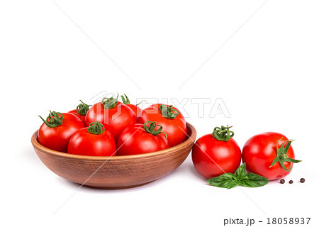 Fresh tomatoes in a bowl with basil isolated 18058937