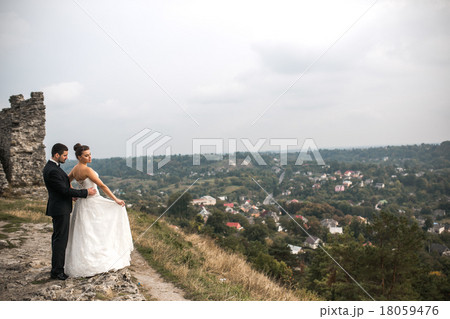 Wedding couple posing for the camera Wedding couple posing for the camera 18059476