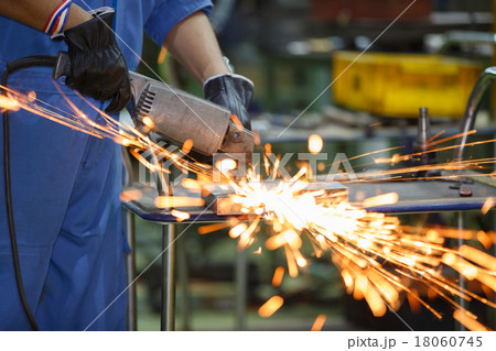 worker grinding steel by electric grinding machine worker grinding steel by electric grinding machine 18060745