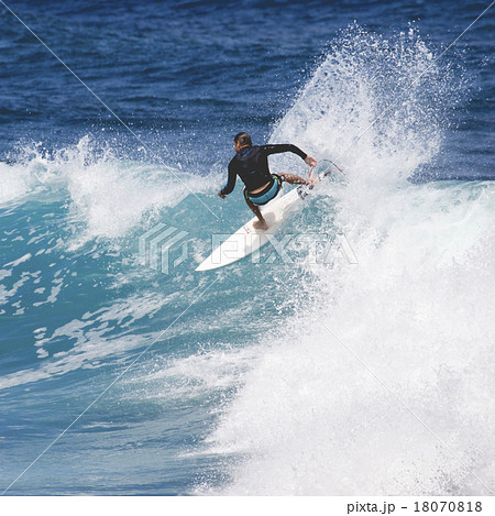 Extreme surfer riding giant ocean wave in Hawaii 18070818