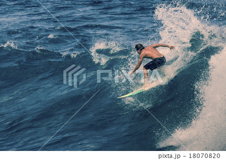 Extreme surfer riding giant ocean wave in Hawaii 18070820