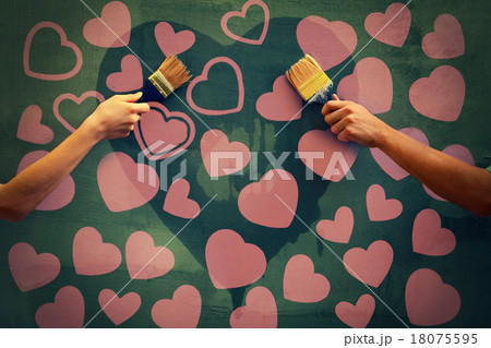 Male and female hands painting concrete wall 18075595